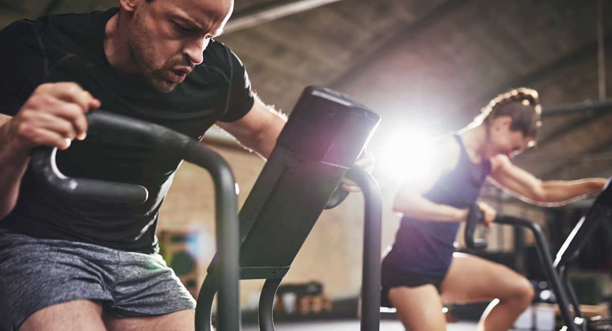 man and woman at the gym, trying harder